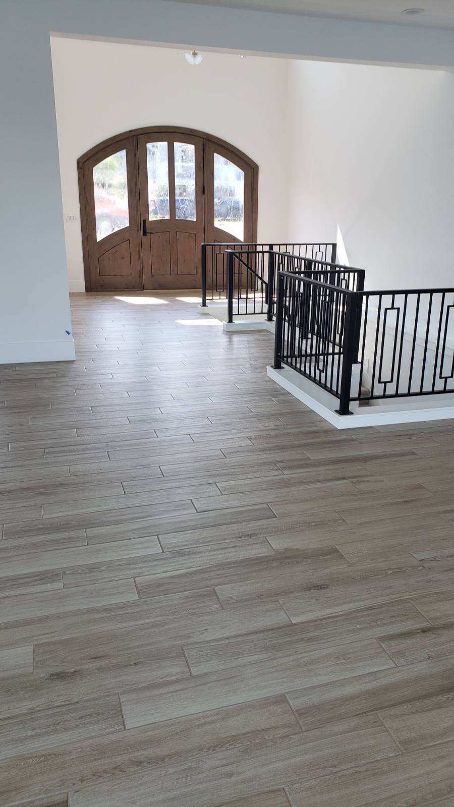 Wood-look tile entryway floor with arched front door in Wenatchee WA